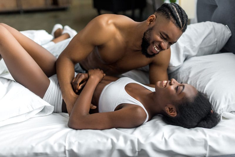 african american couple smiling and hugging on bed 2024 11 17 23 59 12 utc
