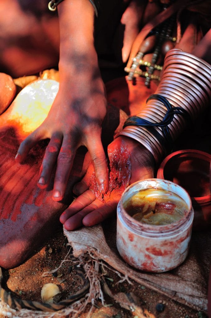 Traditional Healers in Kenya & South Africa 2 himba woman mixing red ochre with petroleum jelly 2025 01 09 05 21 10 utc