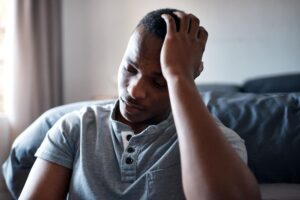 Why You Keep Feeling Stuck in Life, Here’s the Reason You Need to Know 1 bedroom tired black man with depression insomnia stress sad after break up home male person trauma frustrated with headache relationship crisis anxiety heartbreak house 590464 494867
