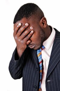 frustrated black man closeup picture suit holding his hand his face sadness white background 36048692