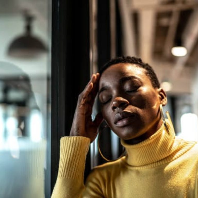 Worried young businesswoman at corridor office