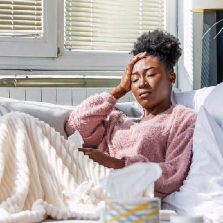 Cold And Flu. Portrait Of Ill African AmericanWoman Caught Cold, Feeling Sick And Sneezing In Paper Wipe. Closeup Of Beautiful Unhealthy Girl Covered In Blanket Wiping Nose. Healthcare Concept.