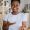 African American woman at home, gesturing to camera