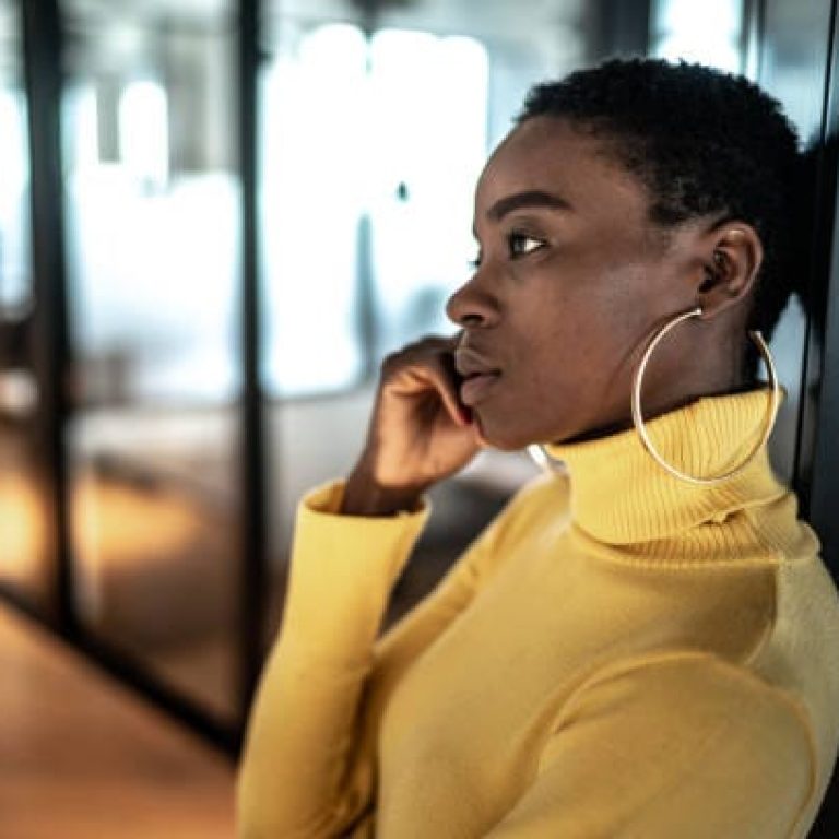 Young business woman looking away and contemplation at work