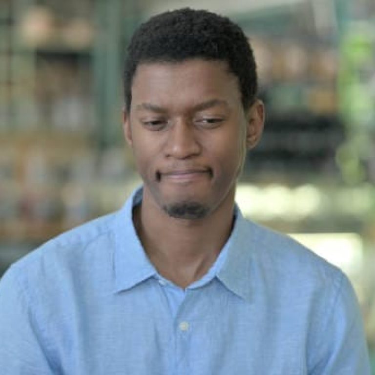 Portrait of Upset Young African Man feeling Sad at Camera