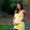 A pregnant woman from Kenya in green park landscape.