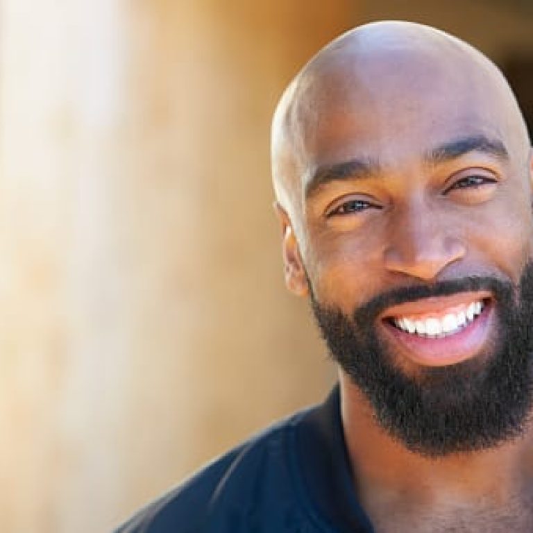 Portrait Of Smiling African American Man Outdoors In Garden At Home
