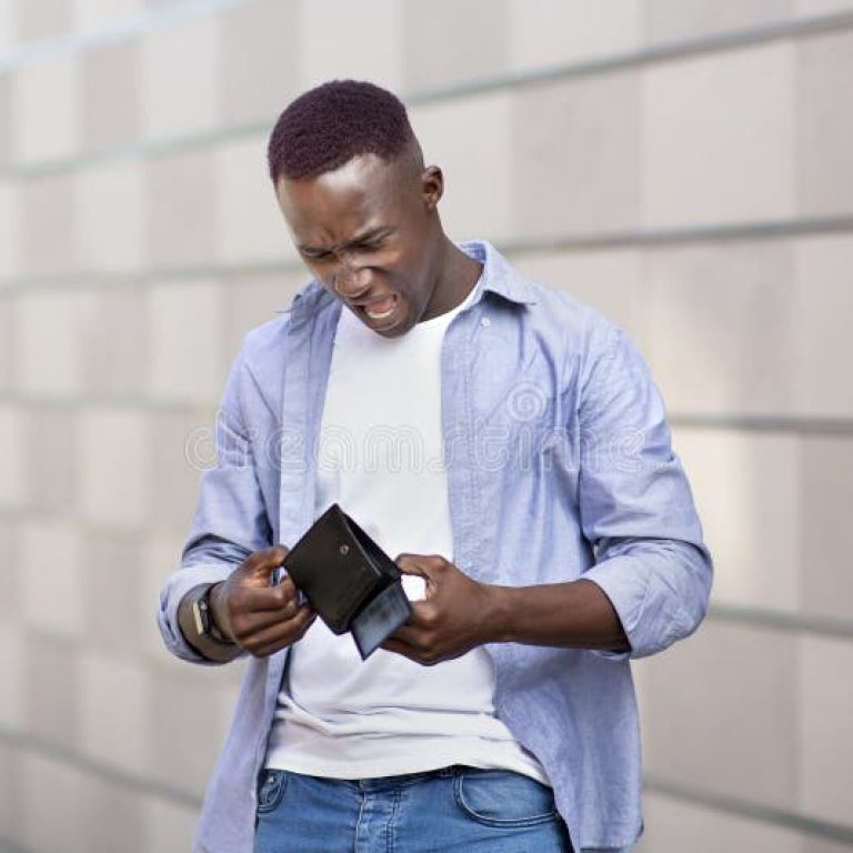 desperate-african-american-guy-looking-his-empty-wallet-near-brick-wall-city-street-unhappy-black-man-no-cash-his-216681321