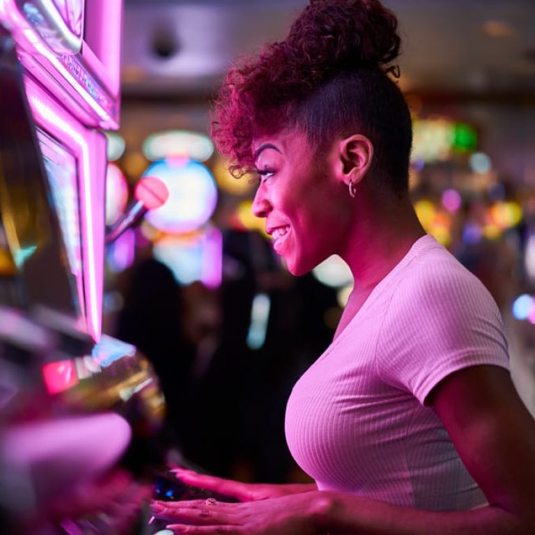 happy-woman-gambling-at-casino-playing-slot-machin-2023-11-27-05-32-22-utc (1)