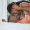 Happy and romantic african american couple lying in bed together at home and being intimate. Playful black boyfriend and girlfriend bonding together with their foreheads touching. Love and passion