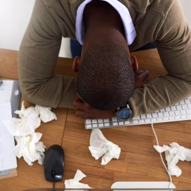 man-flu-struggle-is-real-high-angle-shot-young-businessman-feeling-ill-his-work-desk_590464-14115